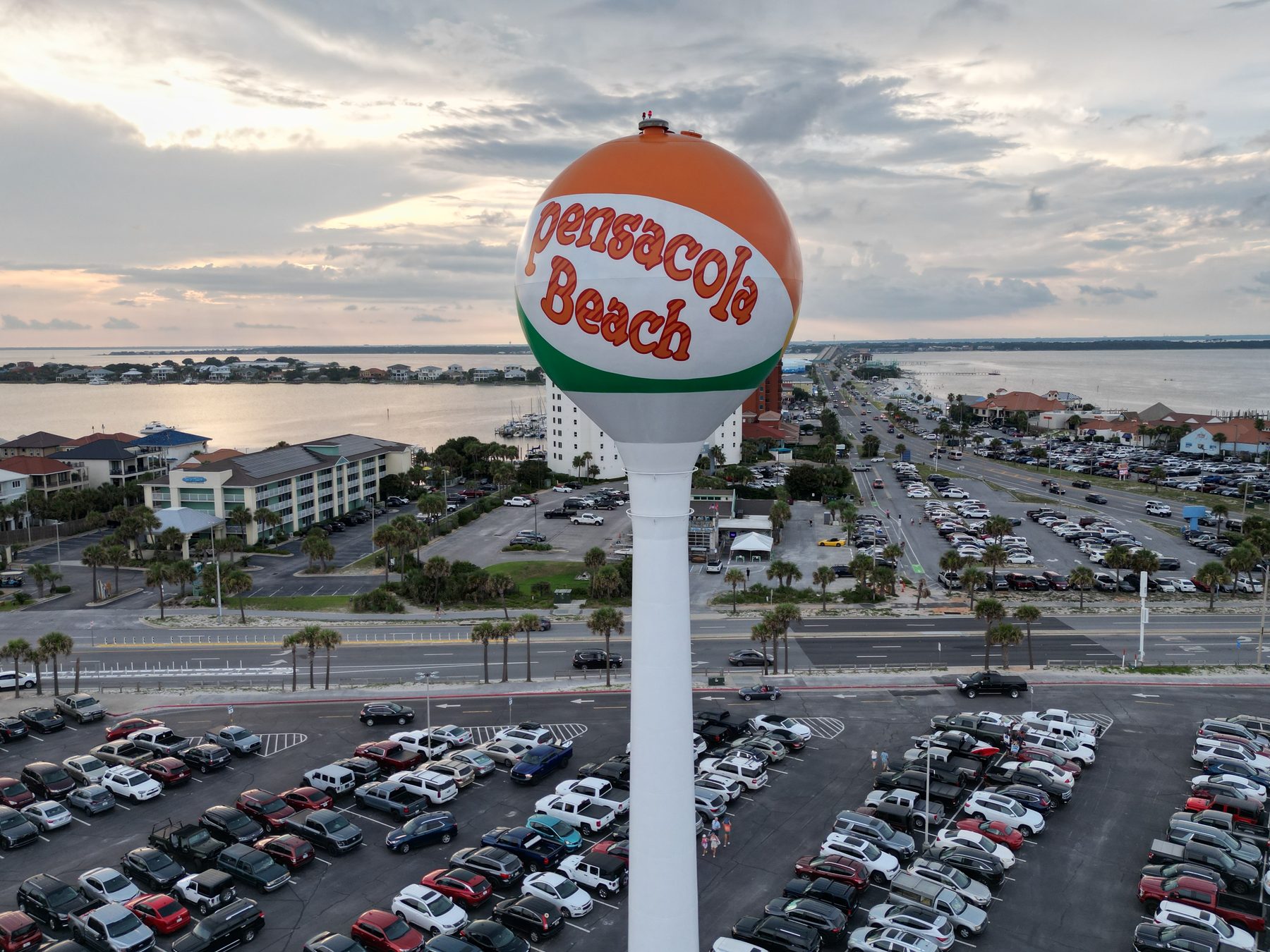 Drone view of the iconic Pensacola Beach beach-ball water tower with the island skyline behind