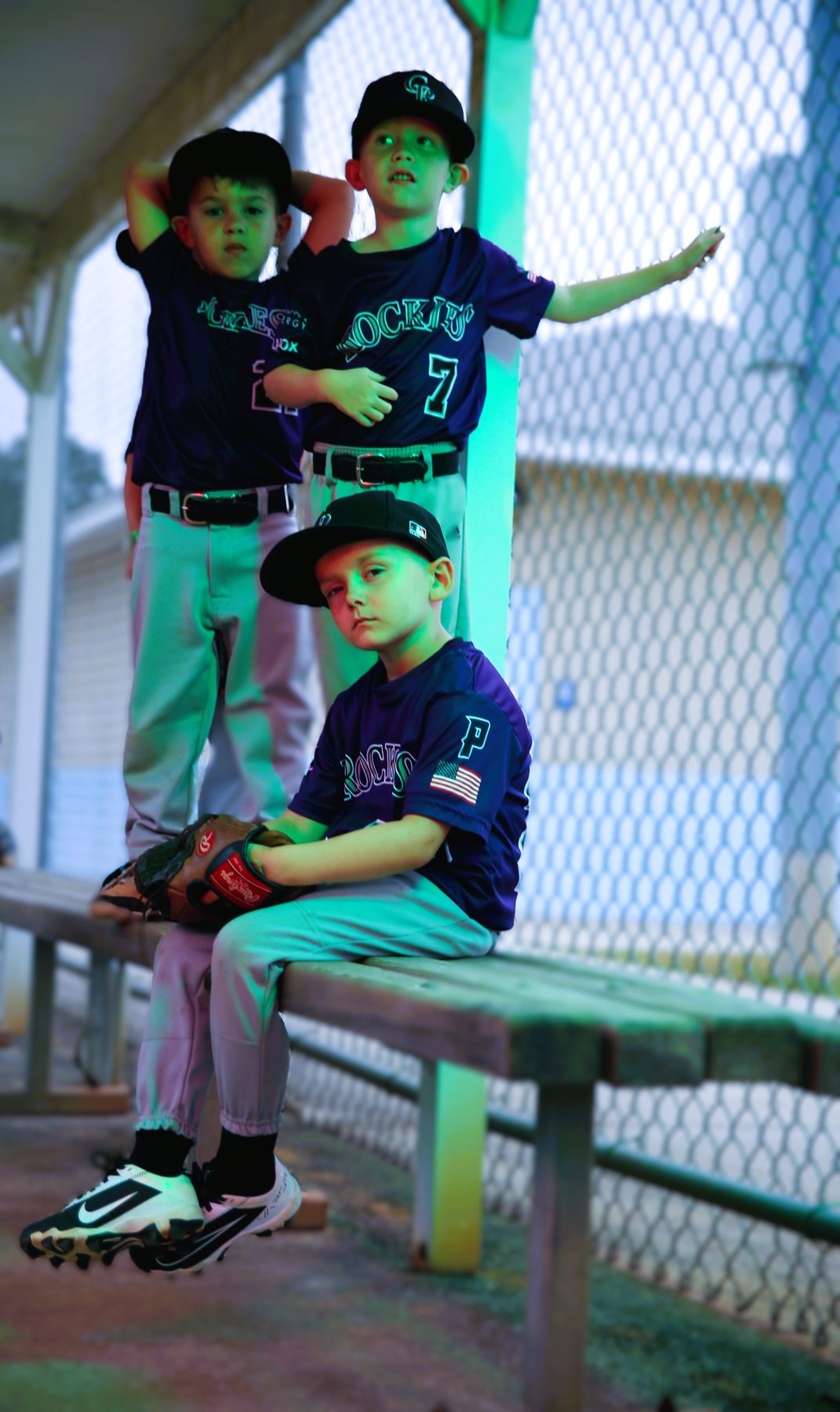 Young teammates celebrating in the dugout