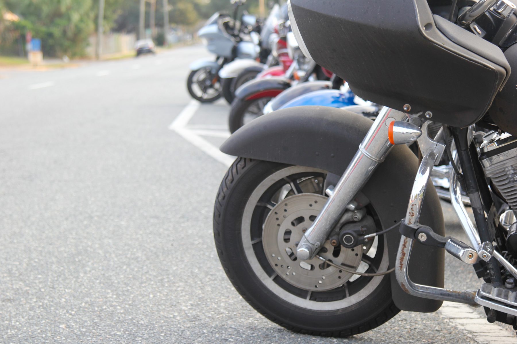 Row of touring motorcycles parked at a Pensacola event