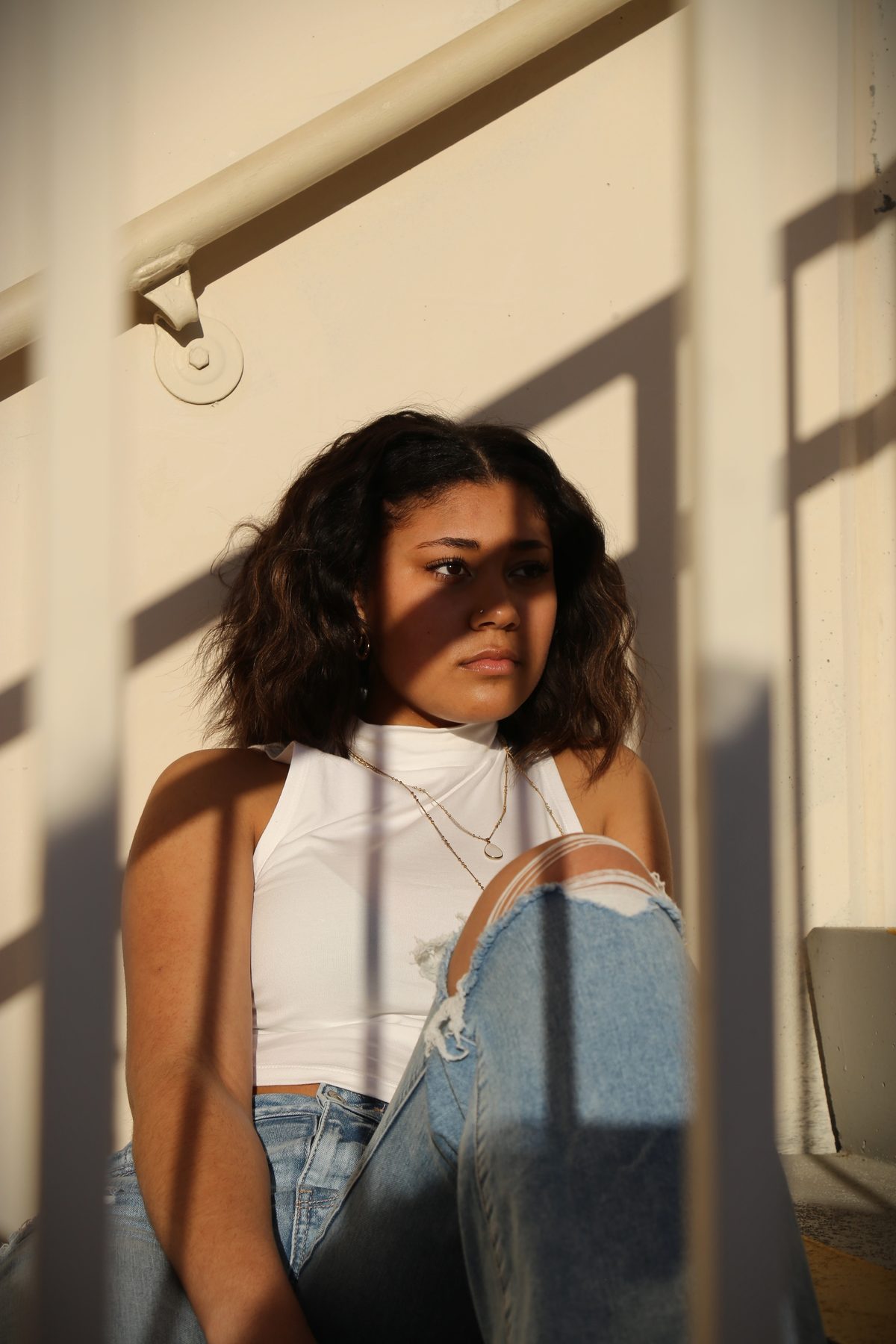Young woman in dramatic window light and shadow